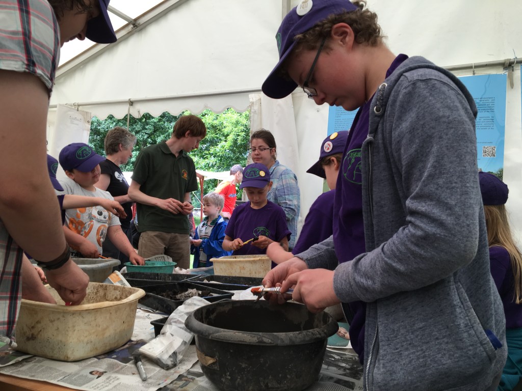 Children washing archaeological finds during an excavation at Bradgate Park.