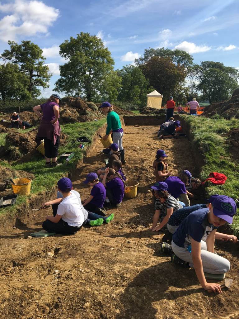 Children excavating in an archaeological trench on Hare Pie Bank at Hallaton.
